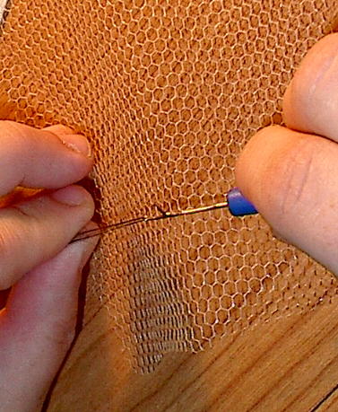 grab the middle of the hairs with the hook